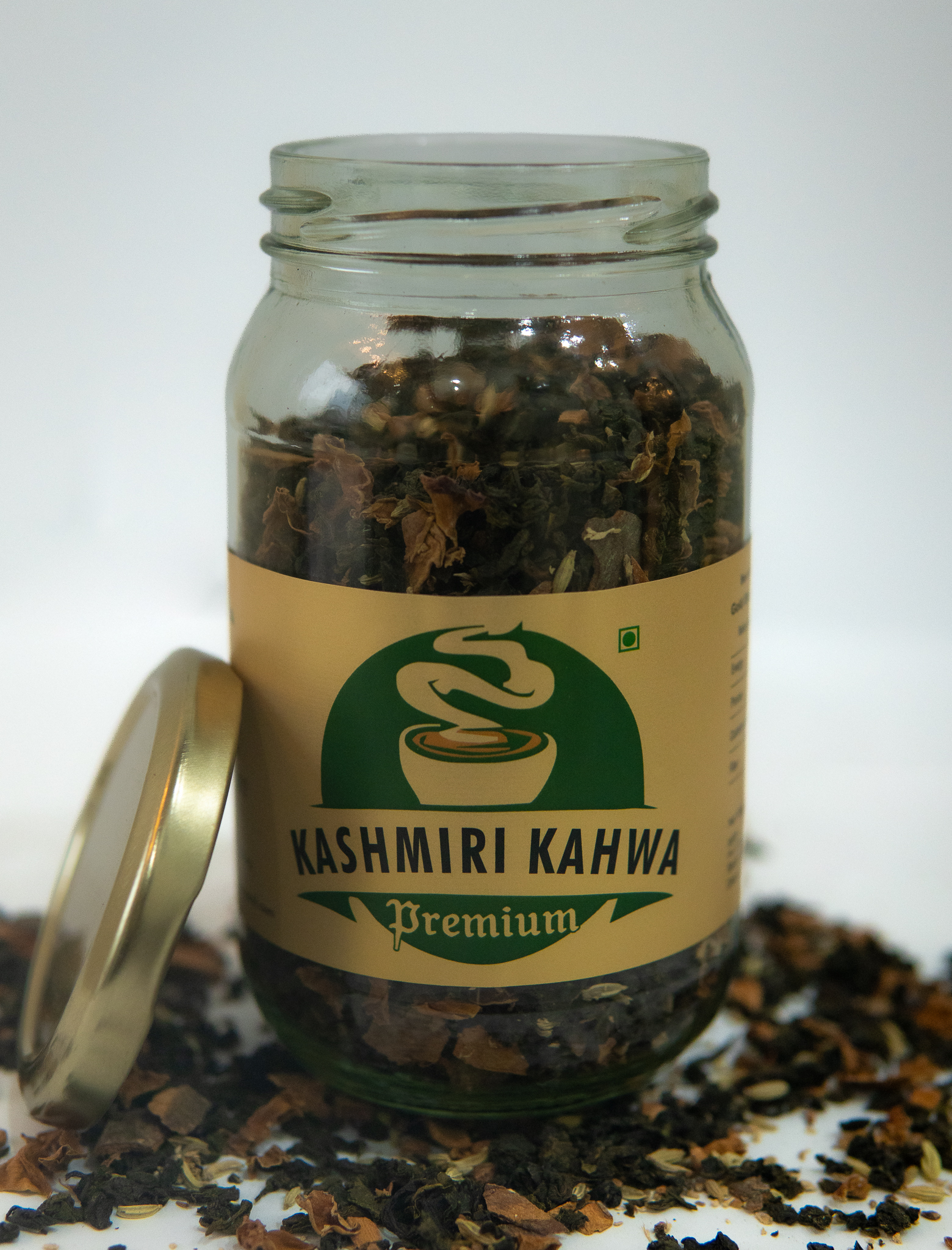 Gold Strong Kashmiri Kahwa Premium tea jar with open lid and loose kahwa leaves