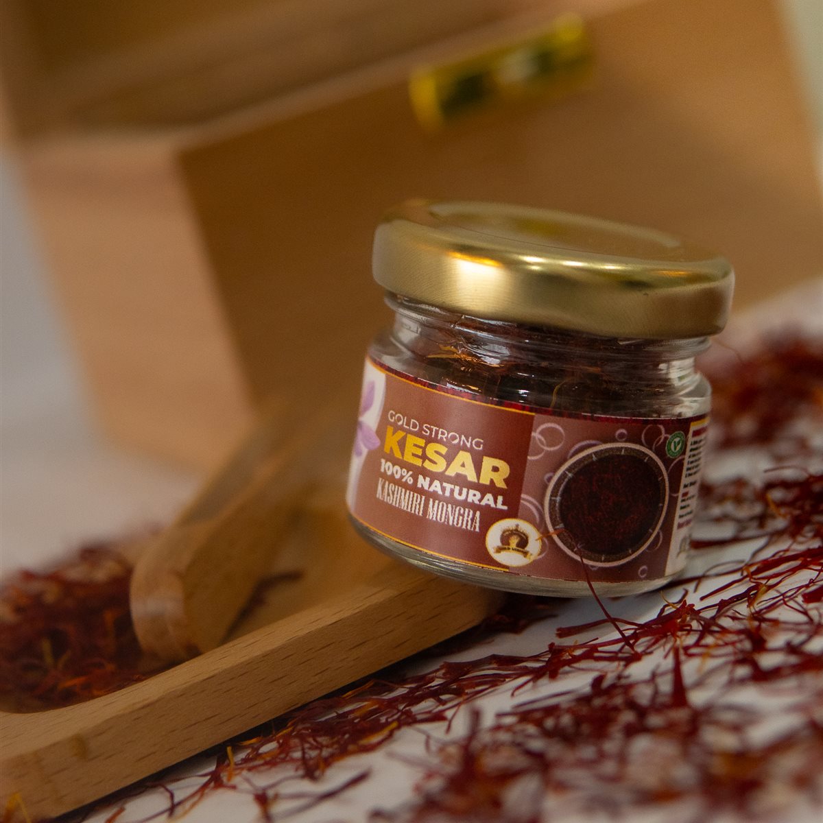 Gold Strong Kashmiri Mongra Kesar jar on wooden tray with saffron threads